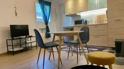 a kitchen with a table and two chairs and a television at ApartHotel Riviera - ISTRIA 1- Old town Promenade des Anglais - Superbe Appartement Superior 2 Pièces AC in Nice
