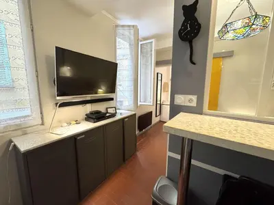 a living room with a flat screen tv on a wall at ApartHotel Riviera - VINCENT 1 - Vieille Ville - Appartement Supérieur 2 pieces AC in Nice