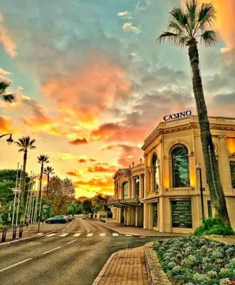 a building on a city street with a palm tree at Nice Vue Mer 50m plage Parking in Nice