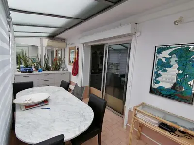 a kitchen and dining room with a table and chairs at Nice Vue Mer 50m plage Parking in Nice