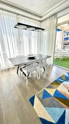 a dining room with a table and a rug at Luxurious 2 Bedrooms Apartment, 30 meter from beach in Nice