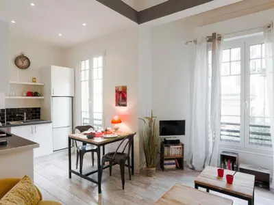 a kitchen and living room with a table at Apartment Le Paganini by Interhome in Nice