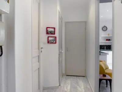 a hallway with white walls and a white door at Apartment Le Paganini by Interhome in Nice
