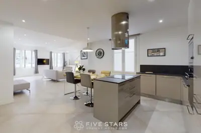 a kitchen and dining room with a table and chairs at Grand Suite Promenade Five stars holiday house in Nice