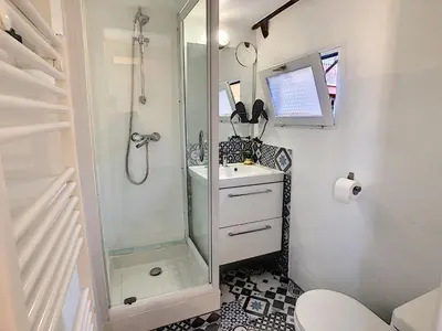 a small bathroom with a shower and a sink at Le Mirador du Vieux Nice in Nice