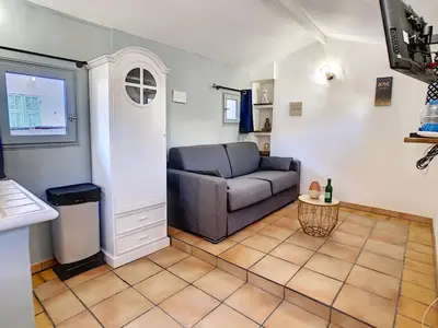 a living room with a couch and a window at Le Mirador du Vieux Nice in Nice