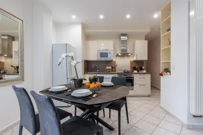a kitchen and dining room with a table and chairs at FEEL HOME - Congrès 13 in Nice