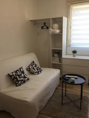 a living room with a couch and a table at Studio à 2 pas de la promenade des anglais in Nice