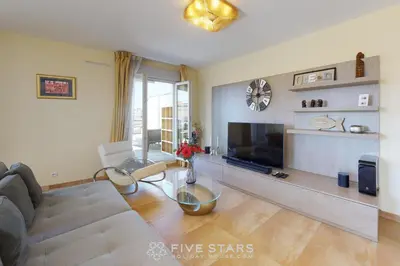 a living room with a couch and a television at LUXURY BEACH five STARS HOLIDAY HOUSE in Nice