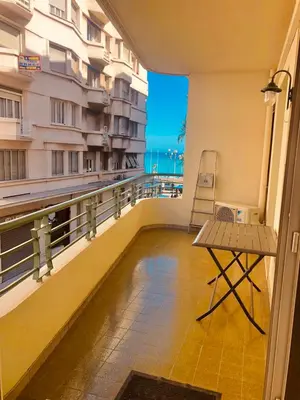 a balcony with a table and a chair on a building at City center cute flat with sea view one bedroom in Nice