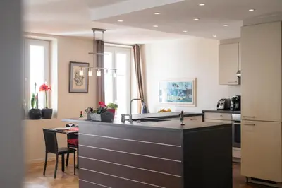 a kitchen with a black counter top and a table at 