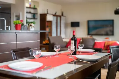 a table with a bottle of wine and glasses on it at 
