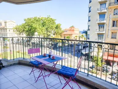 a blue table and two chairs on a balcony at Résidence Les domes, Piscine in Nice