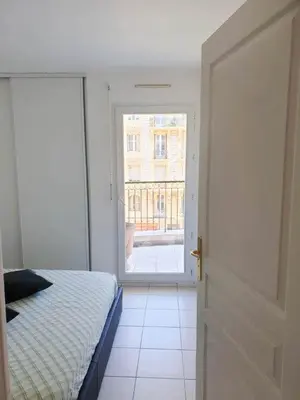 a bedroom with a bed and an open door at Résidence Les domes, Piscine in Nice