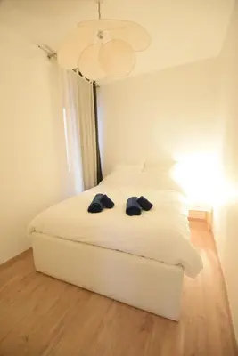 a bedroom with a white bed with two glasses on it at Nice Renting - BARILLERIE - COZY LOFT OLD NICE - SEA FRONT - SALEYA - MASSENA in Nice
