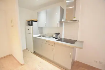 a white kitchen with a sink and a refrigerator at Nice Renting - BARILLERIE - COZY LOFT OLD NICE - SEA FRONT - SALEYA - MASSENA in Nice