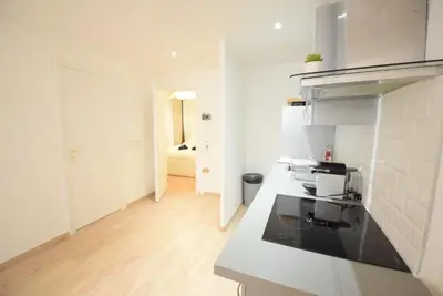 a kitchen with white walls and a counter top at Nice Renting - BARILLERIE - COZY LOFT OLD NICE - SEA FRONT - SALEYA - MASSENA in Nice