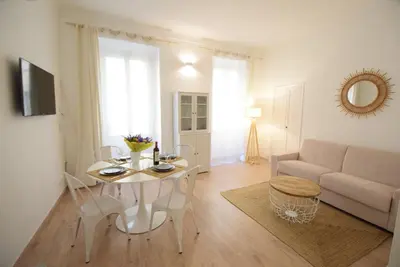 a living room with a table and a couch at Nice Renting - BARILLERIE - COZY LOFT OLD NICE - SEA FRONT - SALEYA - MASSENA in Nice