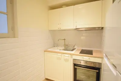 a small kitchen with white cabinets and a sink at Nice Renting - PAIROLIERE - SPACIOUS FLAT - OLD NICE - MASSENA - TERRACE in Nice
