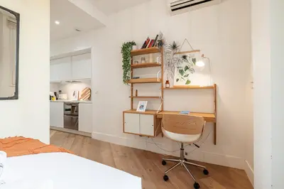 a bedroom with a desk and a bed and a kitchen at 60 HEROLD - Magnifique Studio - Terrasse - Climatise in Nice