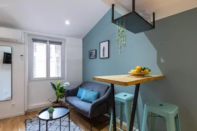 a living room with a table and a chair at 1 GALLO LOT 2 - Studio Mezzanine en plein coeur du vieux Nice in Nice