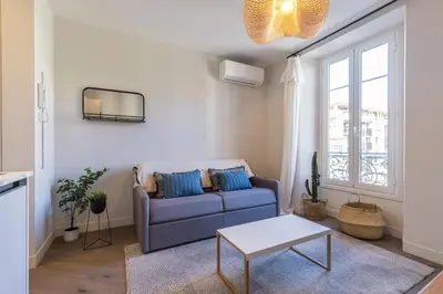 a living room with a blue couch and a table at 2 BAVASTRO - Beau 2 pieces lumineux et cosy - Climatise in Nice