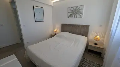 a bedroom with a bed and two lamps on tables at Les Volets Bleus in Nice