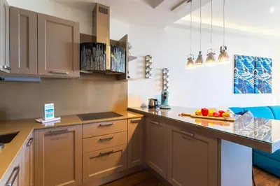 a kitchen with brown cabinets and a counter with fruit on it at BAMBOO PLAGE AP4220 by Riviera Holiday Homes in Nice