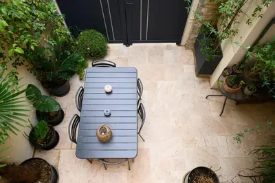a blue suitcase sitting on a floor with plants at Magnifique appartement au centre-ville de Nice in Nice