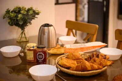 a table with bread and other food on it at Magnifique appartement au centre-ville de Nice in Nice