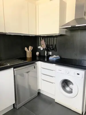 a kitchen with a white washing machine in it at Beautiful T3 terrasse Nice in Nice