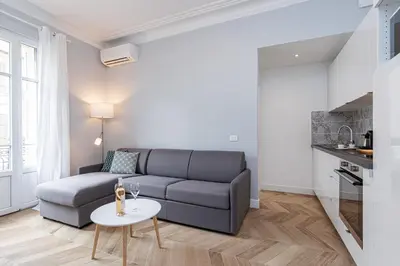 a living room with a couch and a table at ChezDudi in Nice