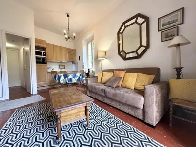 a living room with a couch and a table at ApartHotel Riviera - BALCON HONORE 1 - Old Town - 5 mn Promenade des Anglais et Plage - Charme Absolu - Appartement 2 pièces avec Balcon AC - Vue mer et Ville in Nice