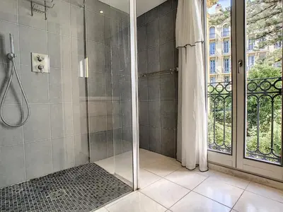 a bathroom with a shower with a glass door at Nestor&Jeeves - GLORY RIVIERA - Central - Close sea in Nice