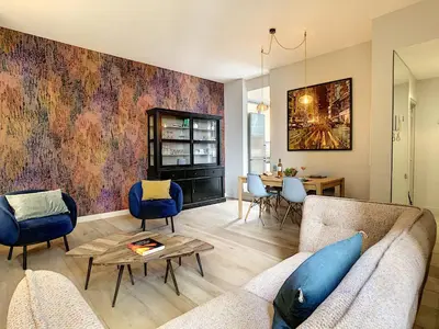 a living room with a couch and a table at Nestor&Jeeves - GLORY RIVIERA - Central - Close sea in Nice