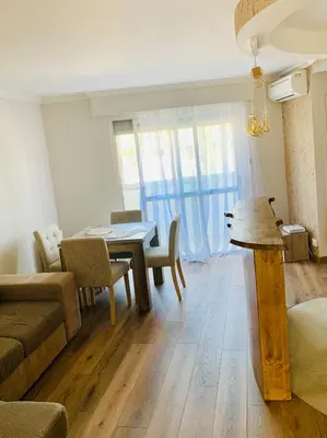 a living room with a table and a couch at Superbe 2 pièces à 50 m de la Promenade des Anglais in Nice
