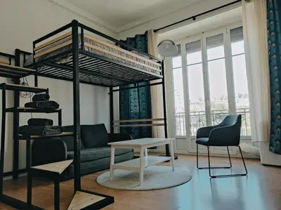 a living room with a bunk bed and a table at Joli Studio - Promenade des Anglais - Accès plage in Nice