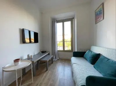 a living room with a couch and a table at Nice Renting - JAURES - Cosy Flat - Nice old town - Great view - AirCon in Nice