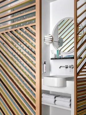 a bathroom with a sink and a mirror at OKKO Hotels Nice Aéroport in Nice