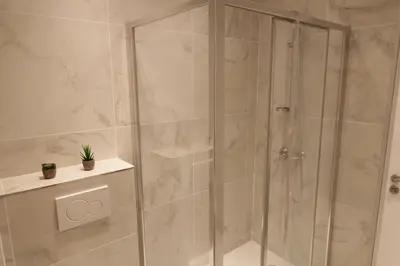 a shower with a glass door in a bathroom at Superbe Appartement au coeur de la vieille ville in Villefranche-sur-Mer