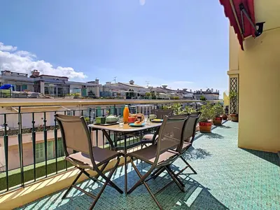 a patio with a table and chairs on a balcony at Nestor&Jeeves - SUNRISE TERRACE - Central - Very close sea - Terrace 30m in Nice