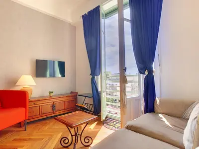 a living room with a couch and a window at Nestor&Jeeves - HAPPINESS BEACH - Central - Close sea - Top floor in Nice