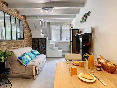 a living room with a couch and a table at Nestor&Jeeves - SECRET BEACH DUPLEX - Very close sea - Atypical in Nice