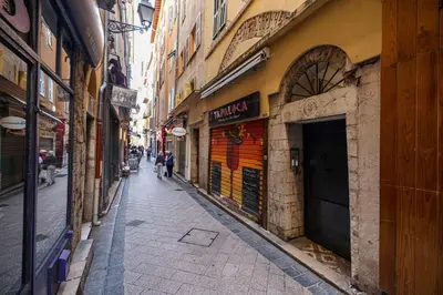 an empty alley with people walking down the street at MY CASA - PONT VIEUX - Duplex Old Town Near Place Rossetti in Nice