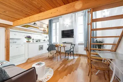a kitchen and living room with a table and chairs at MY CASA - PONT VIEUX - Duplex Old Town Near Place Rossetti in Nice