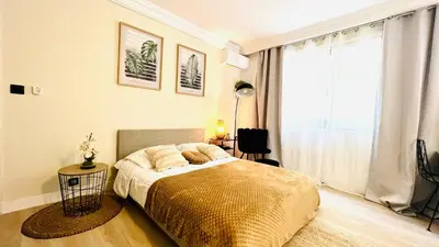 a bedroom with a bed and a large window at LE MIRAMAR Nice - Clim, Parking, Wifi et piscine in Nice