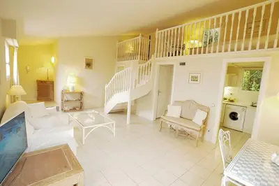 a living room with a staircase and a couch at AMAZING SEA VIEW APARTMENT with Private Close Parking in Saint-Jean-Cap-Ferrat