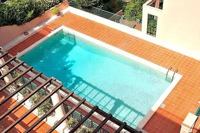 an overhead view of a swimming pool with two chairs at AMAZING SEA VIEW APARTMENT with Private Close Parking in Saint-Jean-Cap-Ferrat