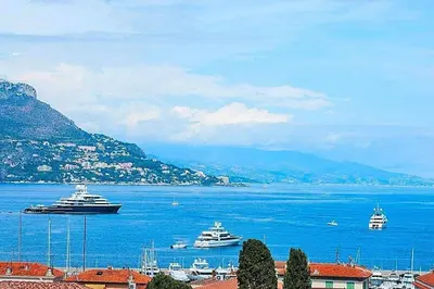 a group of boats in a large body of water at AMAZING SEA VIEW APARTMENT with Private Close Parking in Saint-Jean-Cap-Ferrat