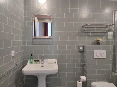 a bathroom with a sink and a mirror at Hotel Aparthotel AMMI Vieux Nice in Nice